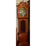 A contemporary cherry wood longcase clock, having arched silvered and brass dial, with three train