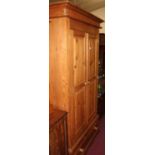 A modern pine double door recess panelled wardrobe, having single long lower drawer, w.103.