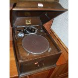 A 1930s oak His Master's Voice table top gramophone, the hinged cover over twin doors