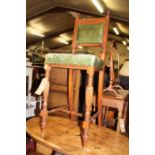 A late Victorian mahogany and green leather pad back and seat childs correction chair, on reeded and
