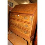 A 1930s figured walnut and crossbanded slopefront three drawer writing bureau, w.80cm