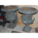 A pair of grey painted cast iron twin handled pedestal garden campagna urns, h.62.5cm
