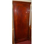 A Victorian mahogany round cornered arched single panelled hall-robe, having interior slides over