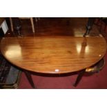A 19th century mahogany and boxwood strung D-end extending dining table, having twin extra drop-in