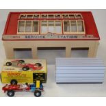 A Dinky Toys plastic service station, a Dinky Toys 1/32 scale Lotus F1 racing car, and an Atlas