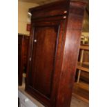An early 19th century oak and mahogany crossbanded single door hanging corner cupboard