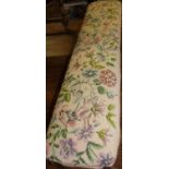 A Victorian rosewood framed and floral tapestry upholstered long footstool, length 110cm