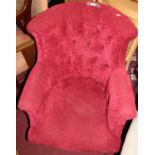 A late Victorian red fabric buttonback upholstered scroll tub armchair, raised on ring turned