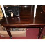A Victorian mahogany round cornered extending dining table, having pull-out action and single drop-