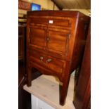 An early 19th century mahogany wash-stand, having twin foldover top over twin cupboard doors to