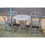 A cast metal circular garden table and four chairs (5)