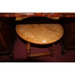 A moulded oak circular low occasional table, dia.60cm