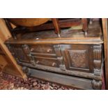 A joined floral relief carved oak sideboard, in the 17th century taste, the twin central drawers