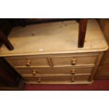 A Victorian pine low round cornered chest of two short over two long drawers, on bun supports, w.