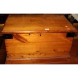 A stained pine and metal bound hinge top tool chest, having end carry handles, width 64.5cm