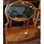 A 19th century mahogany and ebony strung oval swing dressing mirror, raised on bowfront three drawer