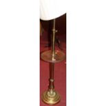 A polished brass telescopic standard lamp, with circular mahogany dished centre tier raised on