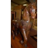 A Spanish carved and stained pine freestanding carousel type horse, with front raised right leg,
