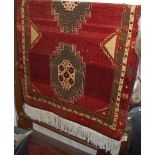 A Persian machine-woven red ground Bokhara rug, 220 x 110cm
