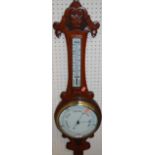 An early 20th century floral relief carved oak aneroid two-dial wheel barometerCondition report: