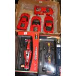 A Burago 1/18 scale Red Bull racing Formula One car; one other Ferrari; and a box containing four