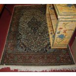 A Persian tight-weave woollen Tabriz rug, having a heavily decorated floral ground within tramline