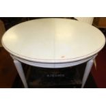 A French cream painted pine circular breakfast table, raised on fluted tapering supports, dia.