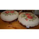 A pair of late Victorian walnut circular and floral embroidered upholstered low footstools, dia.29cm