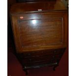 An early 20th century narrow mahogany slopefront three drawer writing bureau, w.55.5cm