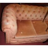 A Victorian pink draylon buttoned upholstered three-seater Chesterfield, raised on bun supports, w.