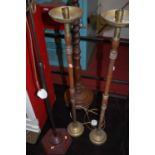 A 1930s barleytwist turned oak standard lamp; together with a pair of candle stands; and a