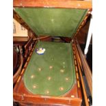 An early 20th century mahogany fold over baize lined bagatelle table, with sundry cues and balls