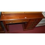 A contemporary hardwood single pedestal desk, having two frieze drawers and single cupboard door,