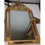 A gilt composition framed wall mirror having cherub and basket of flowers surmount and a moulded