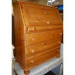 A modern pine slopefront four drawer writing bureau, w.85.5cm