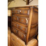 An early 20th century geometric moulded oak chest of four long drawers, in the 17th century taste,