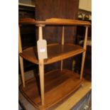 An Ercol light elm three-tier tea trolley, each tier with raised edge, on roller castors, w.71cm