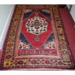 A Persian hand-woven woollen red ground Shiraz rug, with flatweave ends, 230 x 150cm