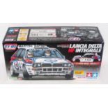 A Tamiya model No. 58342 1/10 scale radio controlled kit for a Lancia Delta HF Integral race car,