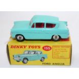 A Dinky Toys No. 155 Ford Anglia comprising turquoise body with red interior and spun hubs, housed