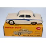 A Dinky Toys No. 179 Austin A105 saloon comprising of cream body with matching hubs and blue side