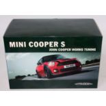 A John Cooper Works 1/18 scale model of a Mini Cooper S diecast vehicle housed in the original