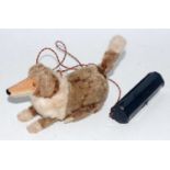 A Japanese tinplate and battery operated model of a standing and rising dog, covered in two-tone