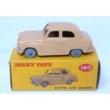 A Dinky Toys No. 160 Austin A30 saloon, comprising tan body with grey plastic wheels housed in the