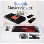 An original boxed as issued Sega Master System video game console, appears complete and unopened, in