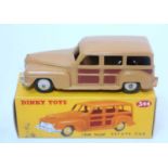 A Dinky Toys No. 344 Estate car comprising of two tone dark brown and light brown body with dark