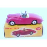 A Dinky Toys No. 101 Sunbeam Alpine saloon comprising of cerise body with cream interior and cream