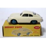 A Dinky Toys No. 182 Porsche 356A comprising of cream body with dark blue hubs and housed in the