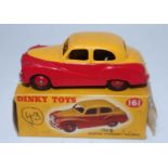 A Dinky Toys No. 161 Austin Somerset saloon comprising of two tone red and yellow body with red hubs