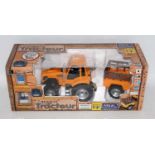 A Nikko radio controlled 27MHZ 1/18 scale Renault tractor and farm trailer, appears as issued,